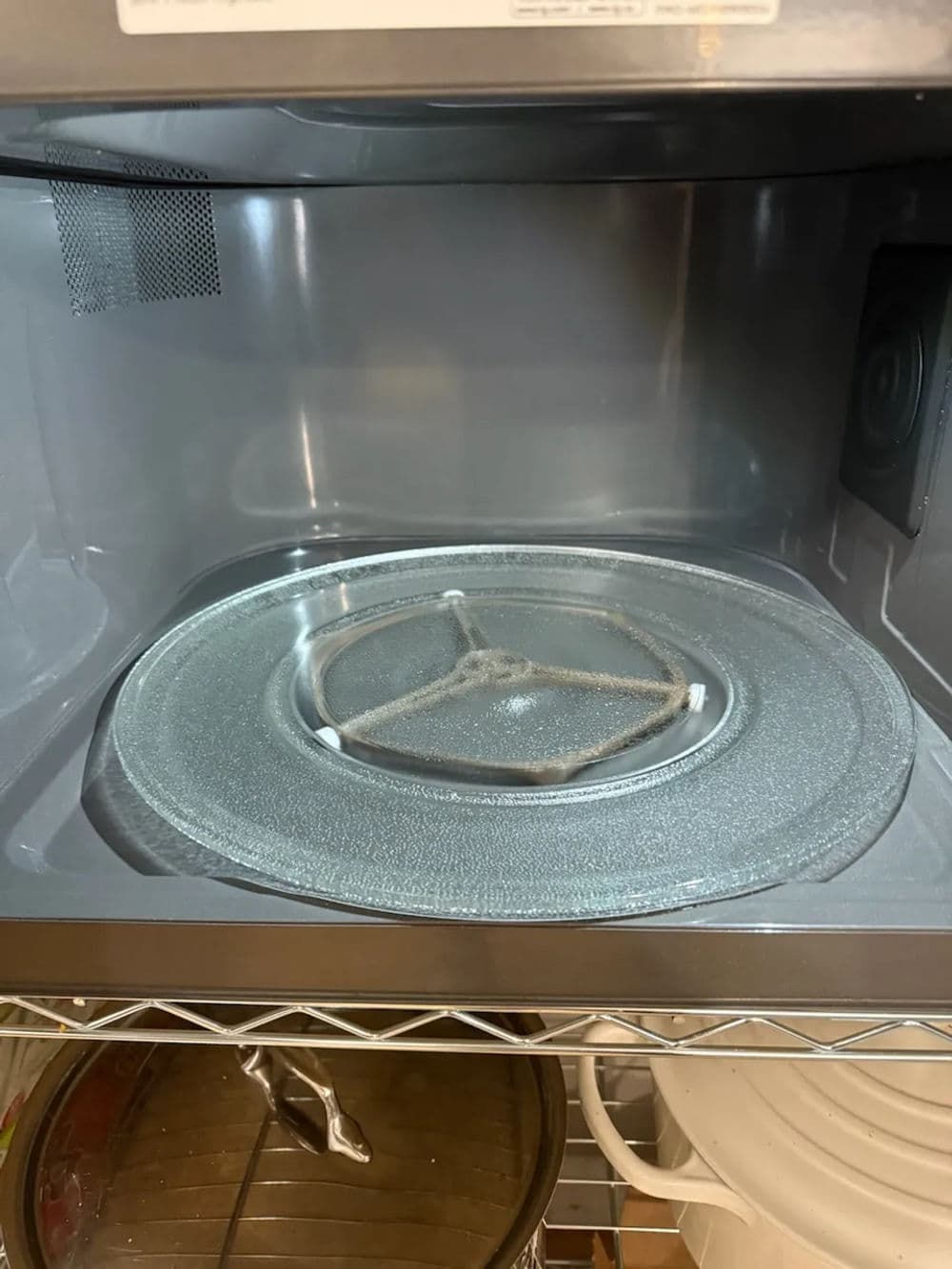 Interior of an empty microwave oven with a glass turntable visible.